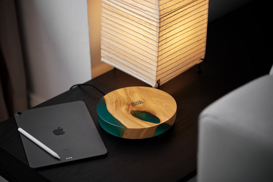 a wooden bowl sitting on top of a desk next to a laptop
