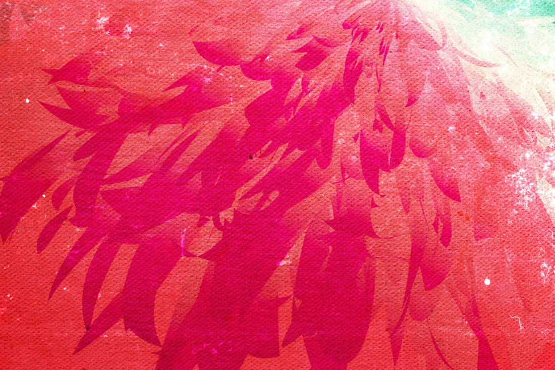 A close up of a pink umbrella on a beach