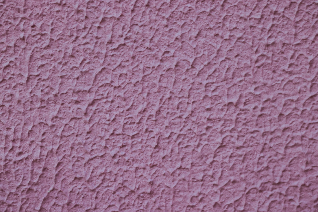 a close up of a pink stucco wall