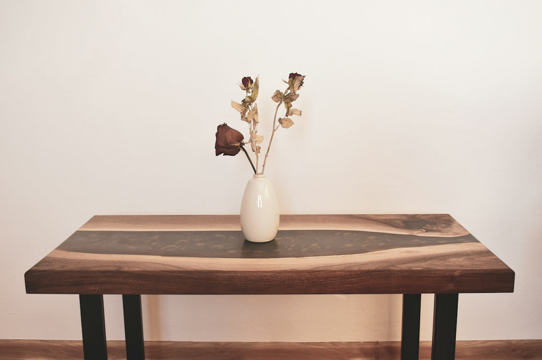 a wooden table with a vase of flowers on top of it