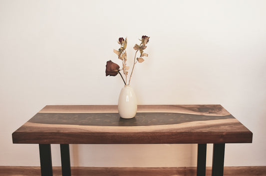 a wooden table with a vase of flowers on top of it