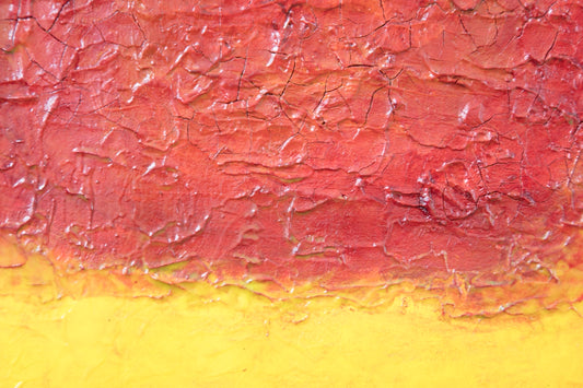 a painting with yellow and red paint on it
