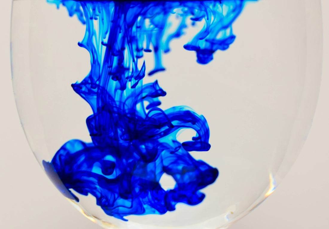a close up of a blue liquid in a glass