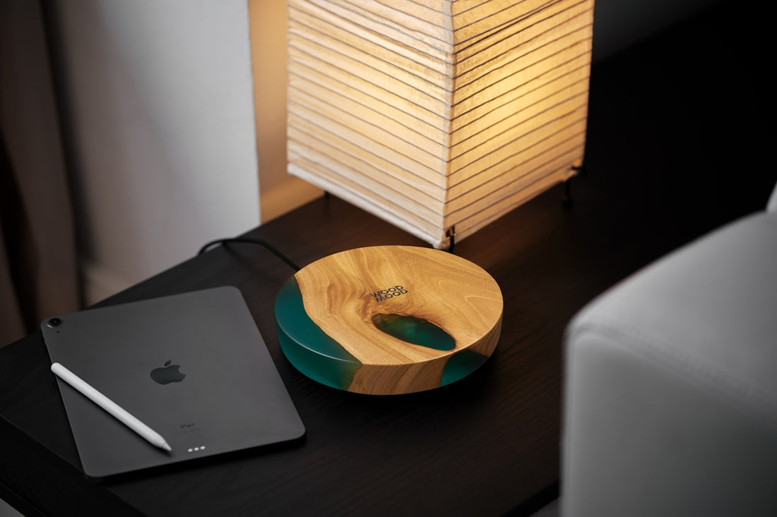a wooden bowl sitting on top of a desk next to a laptop