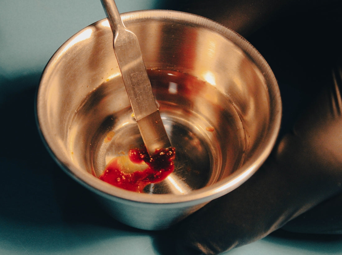 a metal bowl with a spoon inside of it