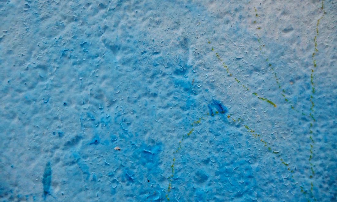 A close up of a wall with blue paint