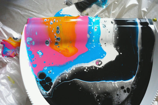 A toilet covered in a plastic bag with a colorful design on it