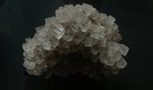 A cluster of salt crystals against a black background.