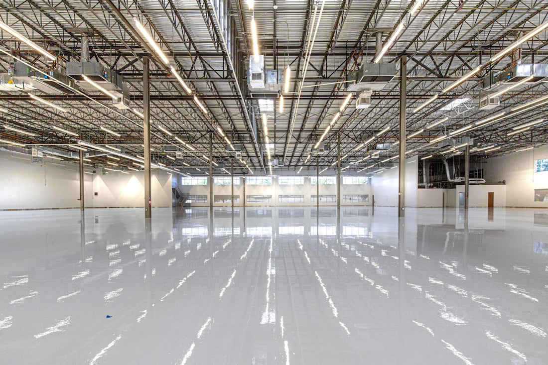 Shiny warehouse floor with overhead lights and ceiling
