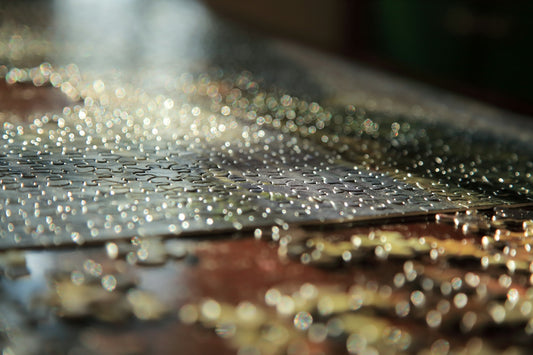 Water droplets on a wooden surface with bokeh lights